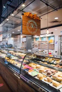 a bakery filled with lots of different types of cakes and pastries in glass cases