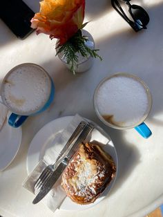 a table topped with plates and cups filled with food