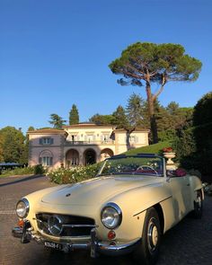 an old car parked in front of a house