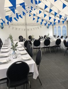 a large tent with tables and chairs set up for a formal dinner or banquet event