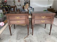 two wooden nightstands sitting next to each other on top of a cement floor in a garage