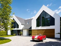 a red sports car parked in front of a house