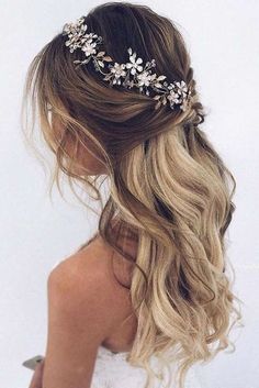 a woman with long blonde hair wearing a floral headpiece