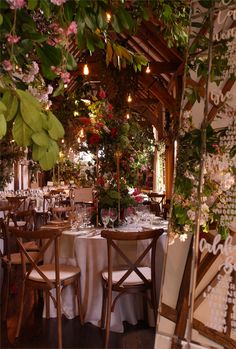 tables and chairs are set up for a formal function in the dining room with floral decorations