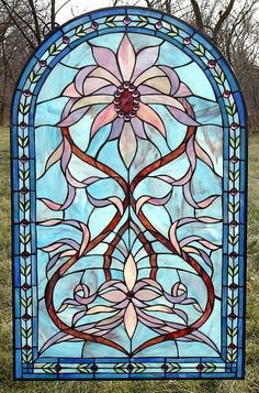 a stained glass window sitting in the grass