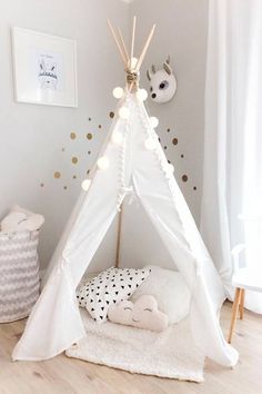 a white teepee tent in a child's room