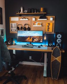 a desk with a computer and speakers on it