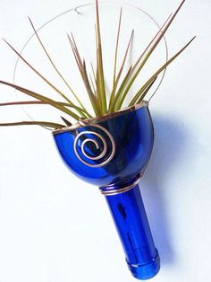 there is a blue vase with some plants in it