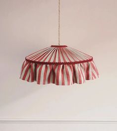 a red and white striped lamp hanging from a ceiling