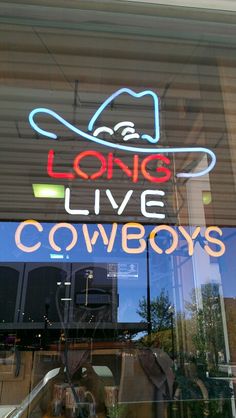 a store front window with the words long live cowboys written on it