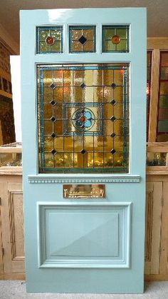 a blue cabinet with stained glass in the front