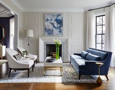 a living room filled with furniture and a fire place in front of a painting on the wall