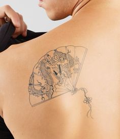 a man with a tattoo on his back