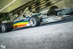 a colorful race car parked in front of a building