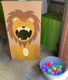 a cardboard box with an image of a lion on it next to some candy balls