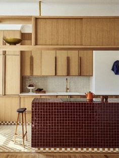 a kitchen with wooden cabinets and checkered flooring on the walls is pictured in this image