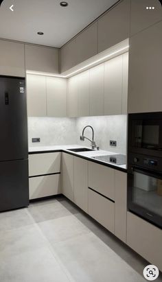 an empty kitchen with black and white appliances