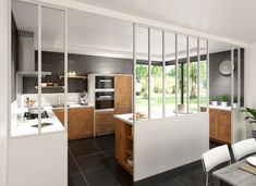 an open kitchen and dining room area with sliding glass doors