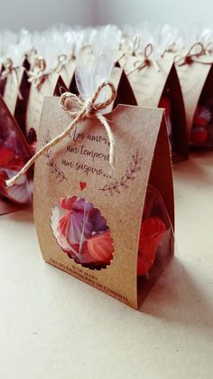 small bags with flowers tied to them sitting on a table