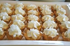 cupcakes with white frosting are on a tray