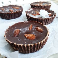 three chocolate cups with nuts on top of them