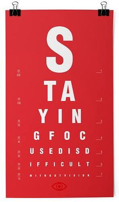 a red poster with an eye chart on it