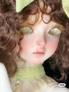 a close up of a doll with brown hair