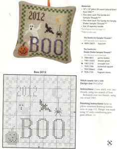 a cross stitch pillow with the word boo on it