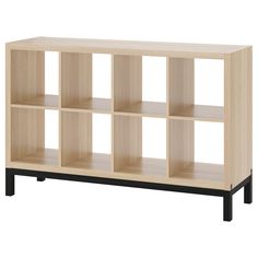 a wooden shelf with six compartments and black legs