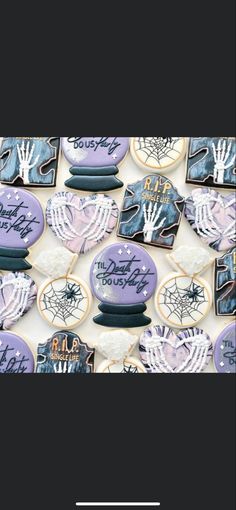 some cookies are decorated with purple icing and spider webs on them for halloween