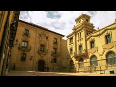 an old yellow building with a clock tower