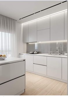 a kitchen with white cabinets and counter tops