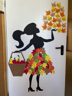 a door decorated with leaves and a woman holding a basket