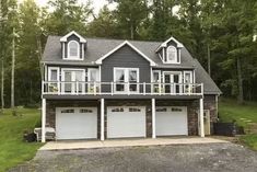 a large house with two garages in front of it