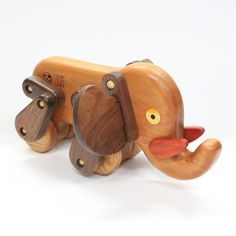 a wooden toy elephant is shown on a white background