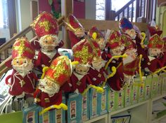 several red and gold santa claus hats on display