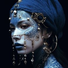 a woman with blue face paint and jewelry