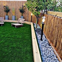 a small backyard with grass and wooden benches