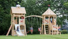 children playing on a wooden play set in the park