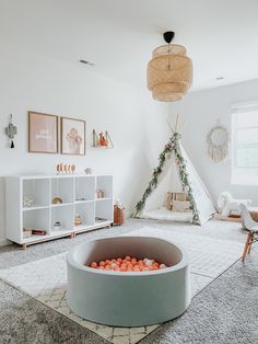 a room with a teepee tent and toys in it