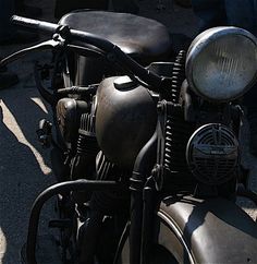 an old motorcycle is parked on the street