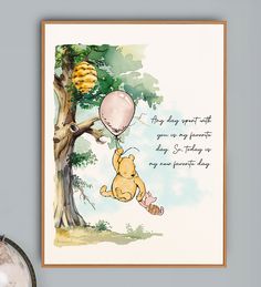 a winnie the pooh birthday card hanging on a wall next to a tree with balloons