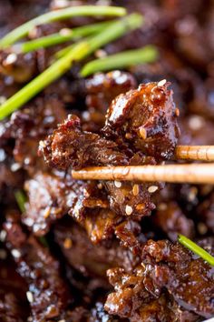 chopsticks sticking out of meat in a bowl