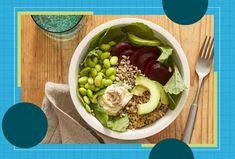 a bowl filled with vegetables and fruit next to a fork