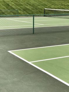 a man standing on top of a tennis court holding a racquet