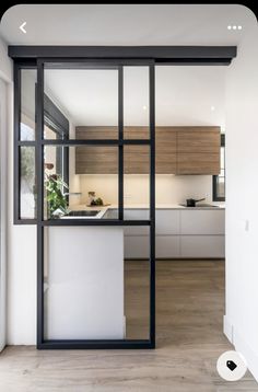 an open kitchen and living room with sliding glass doors