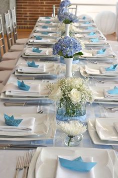 the table is set with blue and white flowers