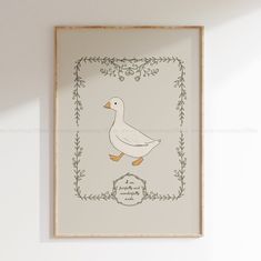 a white duck sitting on top of a wooden floor next to a wall mounted art piece