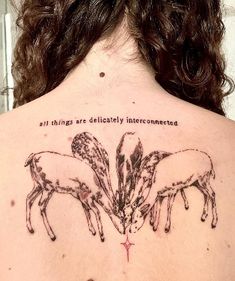 the back of a woman's shoulder with two horses on it and an inscription that says, all things are delicibly interconnecteded