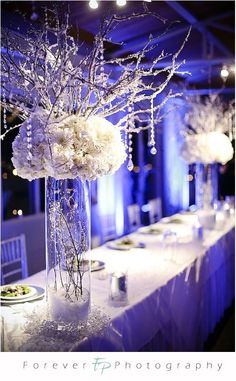 an image of a table setting with flowers and candles on the tables at a wedding